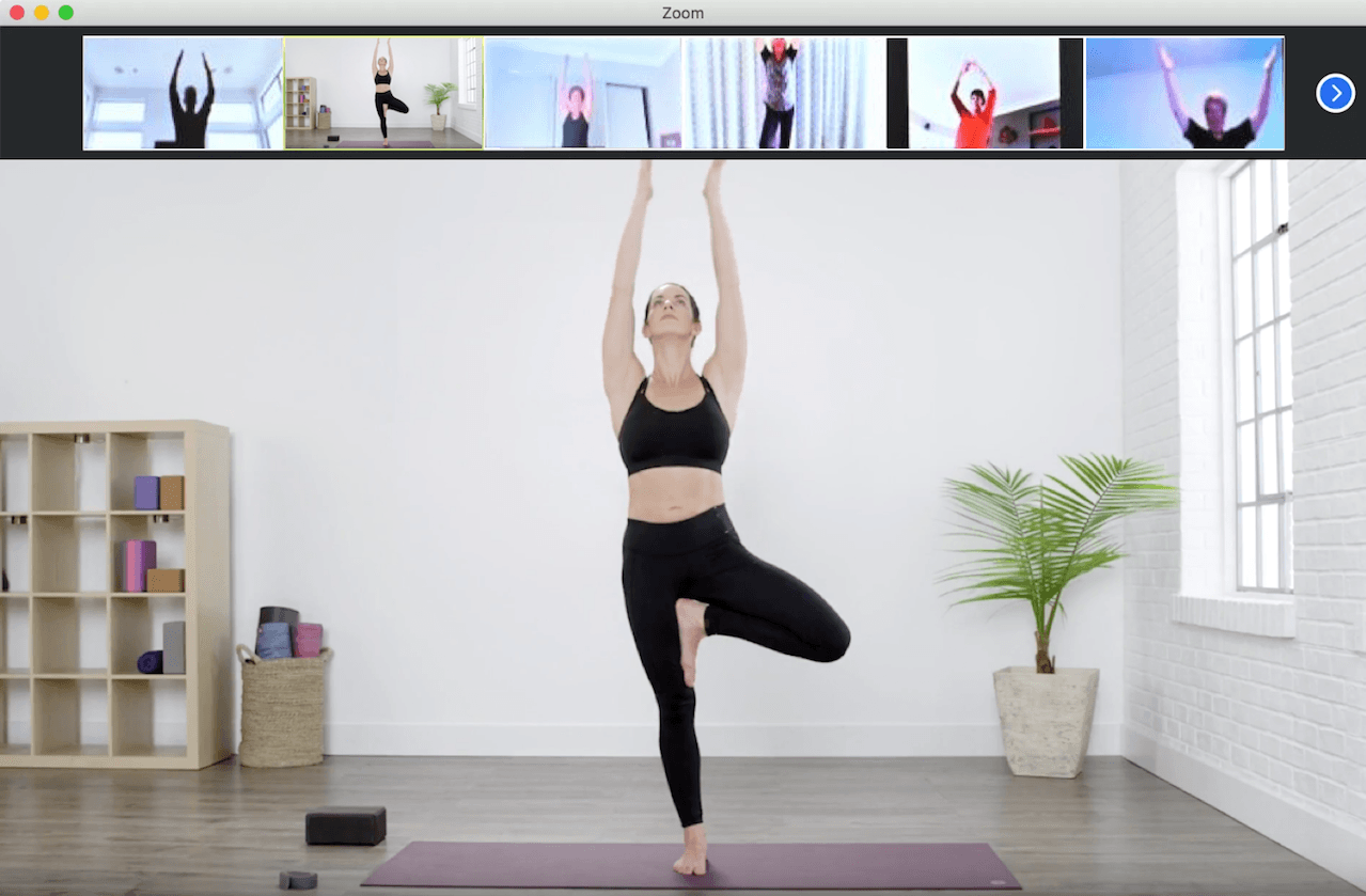 A zoom meeting where a yoga instructor is giving a class to blurred participants
